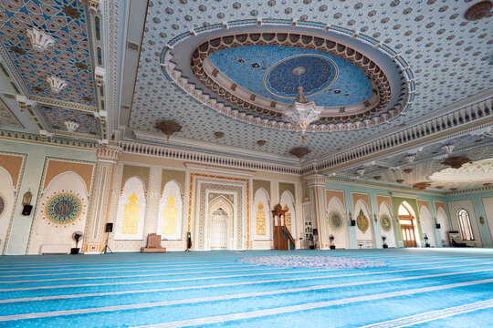 Interior of Hazrati Imam mosque with blue traditional carpet. prayer hall inside mosque.