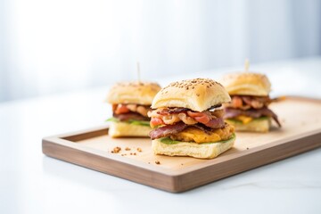 bacon cheeseburger with sesame seed bun on tray
