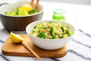fresh broccoli rice in white bowl, wooden spoon beside it