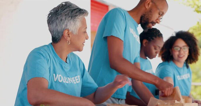 People volunteering, packaging food and donation for community service, poverty support and NGO management. Nonprofit, senior woman or group with groceries, helping outdoor or team in charity project