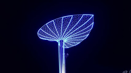 Large illuminated figure of nenuphar water lily leaf at night, decorations for the New Year and Christmas Eve. City lighting in Soho Square, Sharm El Sheikh. Tourism travel in Egypt