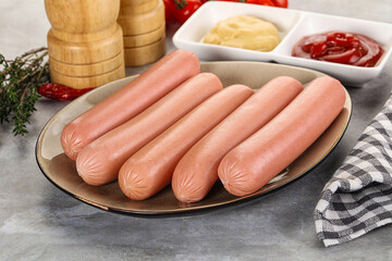 Boiled sausages with ketchup and mustard