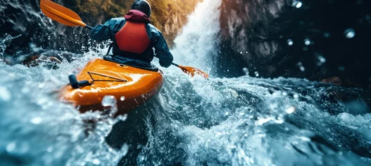 Foto op Canvas Paddling a kayak through rapids in mountain waterfall. © Chrixxi