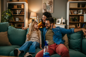 A happy family chatting and connecting on the couch in their living room