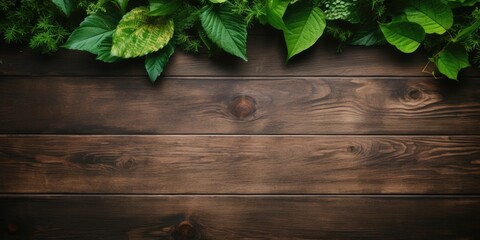 Green leafs serve as a frame for a wooden table top with space for text.