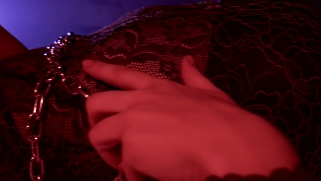 Sexual arousal abstinence excitement. BDSM fetish. Lust. Desire passion temptation. Girl bound in metal chain, she is lying in bed. Intimate adult games, punishment. Hot mistress. Female pervert slave