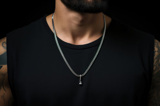 Close-up of a man's neck with a sleek, stainless steel chain necklace, industrial in design