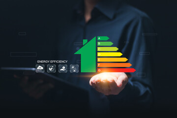 Energy efficiency concept. Businessman use tablet with virtual screen of energy efficiency rating...