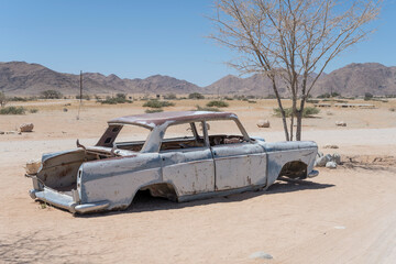 vintage 60's car-body worn down by rust in exibition at Solitaire, Namibia
