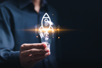 Startup business concept, strategic planning and business success. Businessman hold light bulb with...