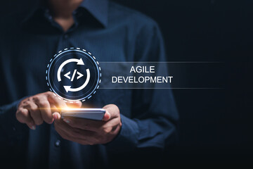 Agile development methodology, businessman use smartphone with virtual screen of agile icon for process that will help you work faster By reducing step-by-step work and focusing on team communication.