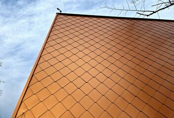 bronze tiles lining the walls of the house, squares similar to fish scales. shiny luxury. modern...