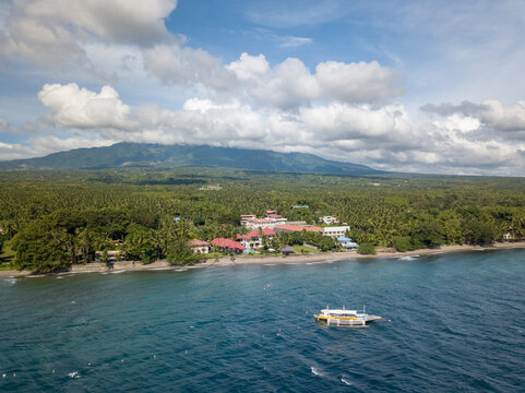 Scenic Panorama Aerial Drone Picture of the coast of Dauin, Dumaguete, Philippines with Mount Talinis in the background