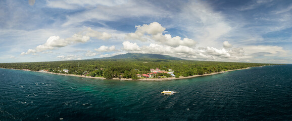 Scenic Panorama Aerial Drone Picture of the coast of Dauin, Dumaguete, Philippines with Mount Talinis in the background