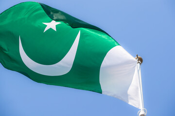 National flag of Pakistan. Pakistan flag against blue sky. Great for news. Waving flag of Pakistan