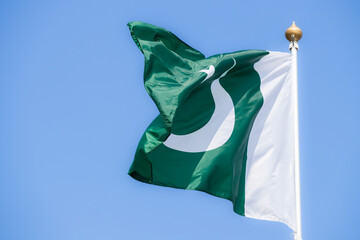 National flag of Pakistan. Pakistan flag against blue sky. Great for news. Waving flag of Pakistan