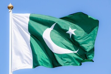 National flag of Pakistan. Pakistan flag against blue sky. Great for news. Waving flag of Pakistan