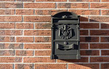 Vintage mailbox on a brick wall at home