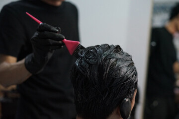 Hair coloring using a brush, in the salon