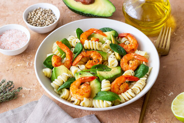 Pasta salad with shrimps, avocado and spinach. Healthy eating. Seafood.