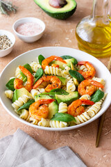 Pasta salad with shrimps, avocado and spinach. Healthy eating. Seafood.
