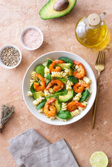 Pasta salad with shrimps, avocado and spinach. Healthy eating. Seafood.