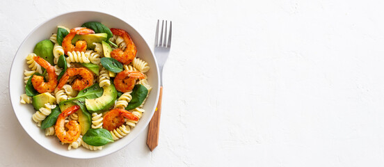 Pasta salad with shrimps, avocado and spinach. Healthy eating. Seafood.