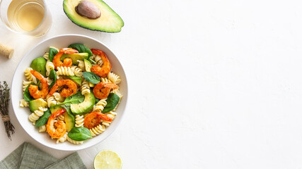 Pasta salad with shrimps, avocado and spinach. Healthy eating. Seafood.
