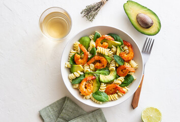 Pasta salad with shrimps, avocado and spinach. Healthy eating. Seafood.