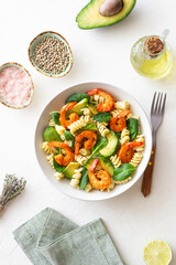 Pasta salad with shrimps, avocado and spinach. Healthy eating. Seafood.