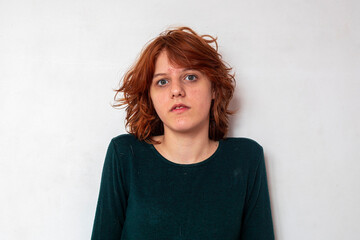 close-up portrait of a pensive teenage girl with red hair with a stylish anime hairstyle