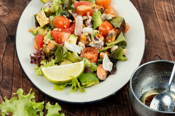 Seafood salad on wooden table.