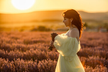 Woman lavender field. happy woman in yellow dress in lavender field summer time at sunset....