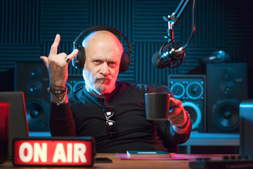 Cool radio host making the sign of the horns
