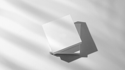 Modern empty podium for product. Minimal white box with shadows on a light background.