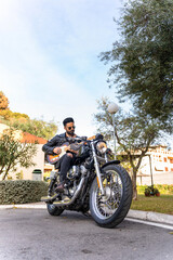 Hipster guitarist playing electric guitar on his motorcycle. Grunge style.