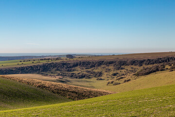 Fototapeta premium Looking out over the Sussex countryside towards the sea, on a sunny winter's day