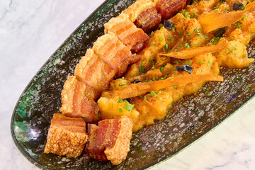 Fried pork with egg yolk and crispy bacon, Japanese food