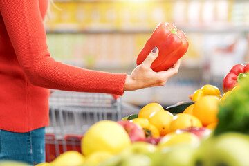 Woman choosing fresh vegetables at the supermarket