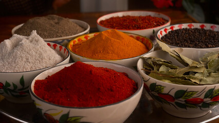 A assortment of colored spices on the kitchen table