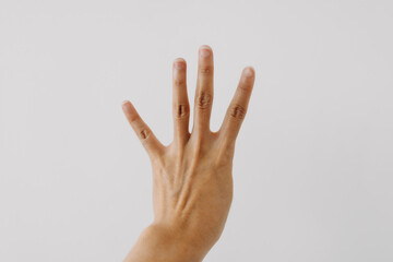 Photo of woman's back hand showing numbers four, counting fingers gesture, isolated on white background wall. - obrazy, fototapety, plakaty