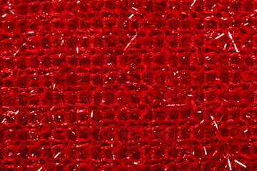 Red fabric with glitter made of polyester. Fabric industry, fabric for making warm clothes