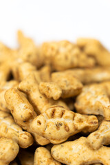 A treat for cats and kittens is a fish-shaped catnip cookie close-up.