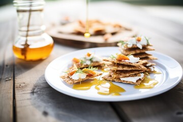 rye crackers with goat cheese, honey drizzle, wooden table