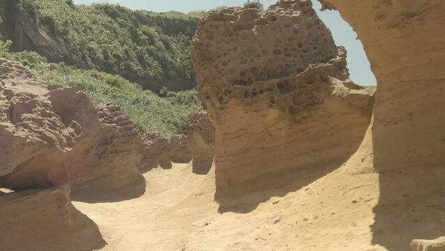 Alien rocks exploration 4k video of Yehliu Natural Geopark in Taiwan near Taipei. Sedimentary yellow rocks with alien shapes. Like walk over martian surface