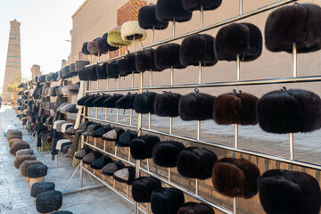 close-up shot of puffy cap. sale of fur hats on street. Khiva, Uzbekistan