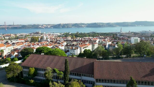 View of Tagus river, Almada city and 25 de Abril bridge from embankment in Lisbon in December