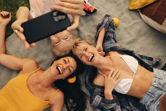 Friends capturing summer memories with a playful selfie