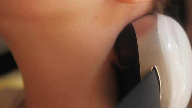 Person use an electric massager at home. Close Up shot.