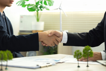 Businessmen make handshakes with partners. business cooperation to comply with environmental laws....